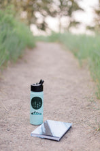 Load image into Gallery viewer, Mountain adventure themed stickers with mountains, pine trees, and "climb on" for rock climbing or hiking on a blue water bottle on a hiking trail.