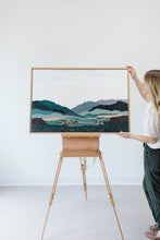 Load image into Gallery viewer, Artist with the painting on an easel.
