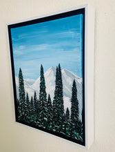 Load image into Gallery viewer, Snow capped mountains, blue sky, with pine trees- cabin view in Breckenridge Colorado fine art canvas acrylic painting. This photo shows the painting framed and includes a visual of the 1.5 inch thick canvas.
